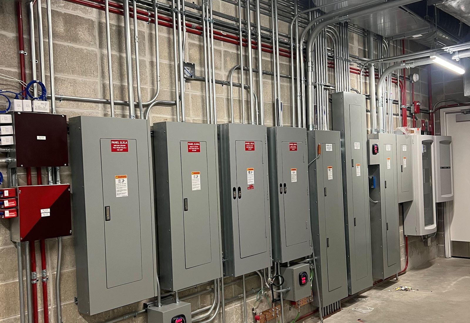Panelboards and conduit runs in an electrical room at UW–Milwaukee's Klotsche Center